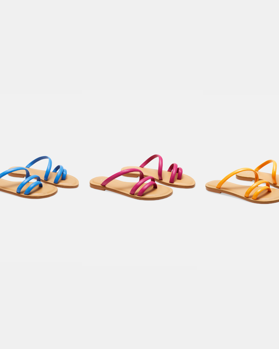 Mangará Begonia pink leather ballerinas worn with a cream crepe dress in a stone courtyard