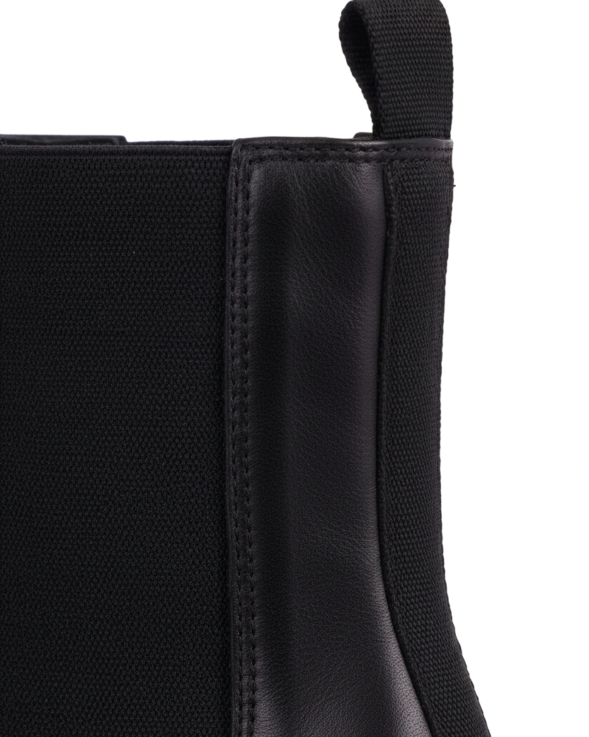 Close up detail of the woven elastic gore and pull tab on the Canna black Chelsea boots