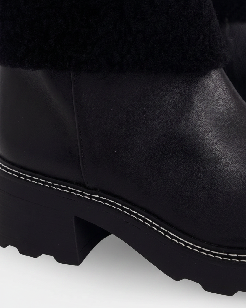 Close up detail of the white contrast stitching along the welt of the Andira black leather boots