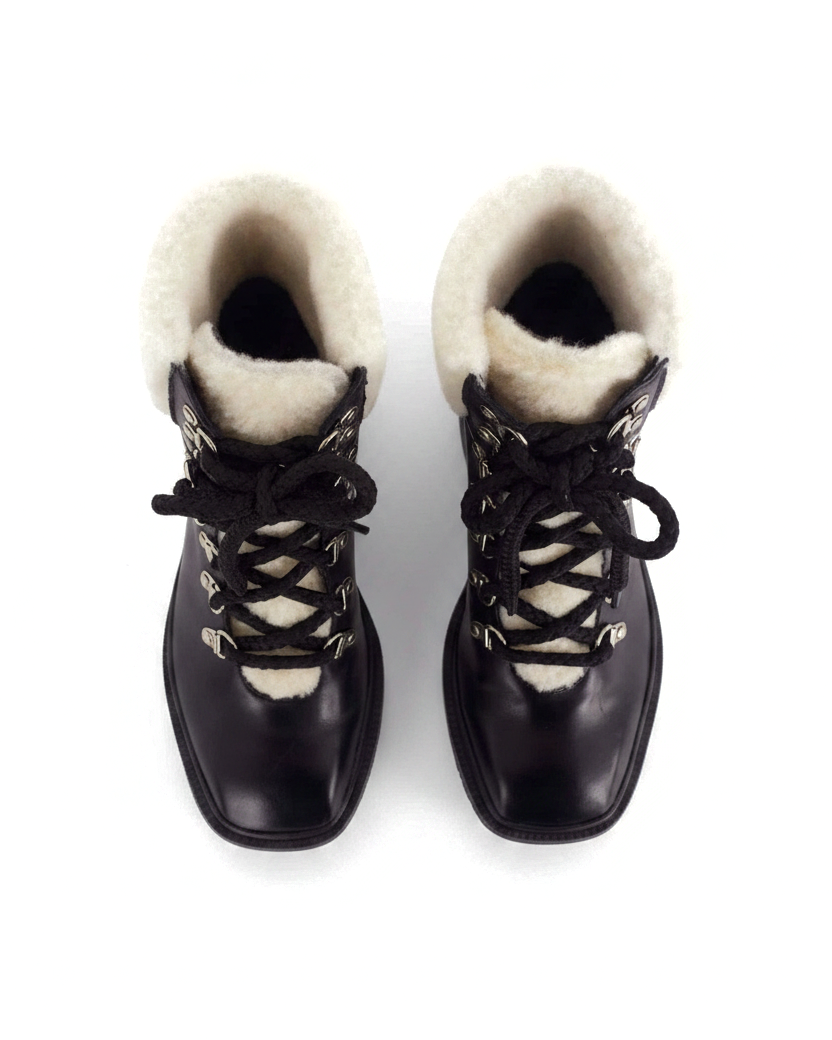 Cassia black leather combat boots top view showing the cream shearling collar and tongue