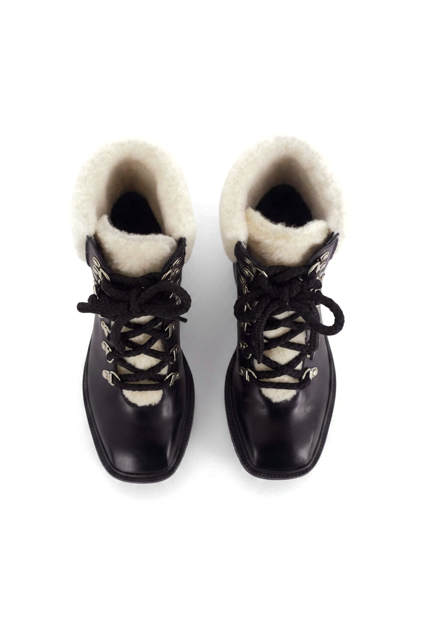 Cassia black leather combat boots top view showing the cream shearling collar and tongue