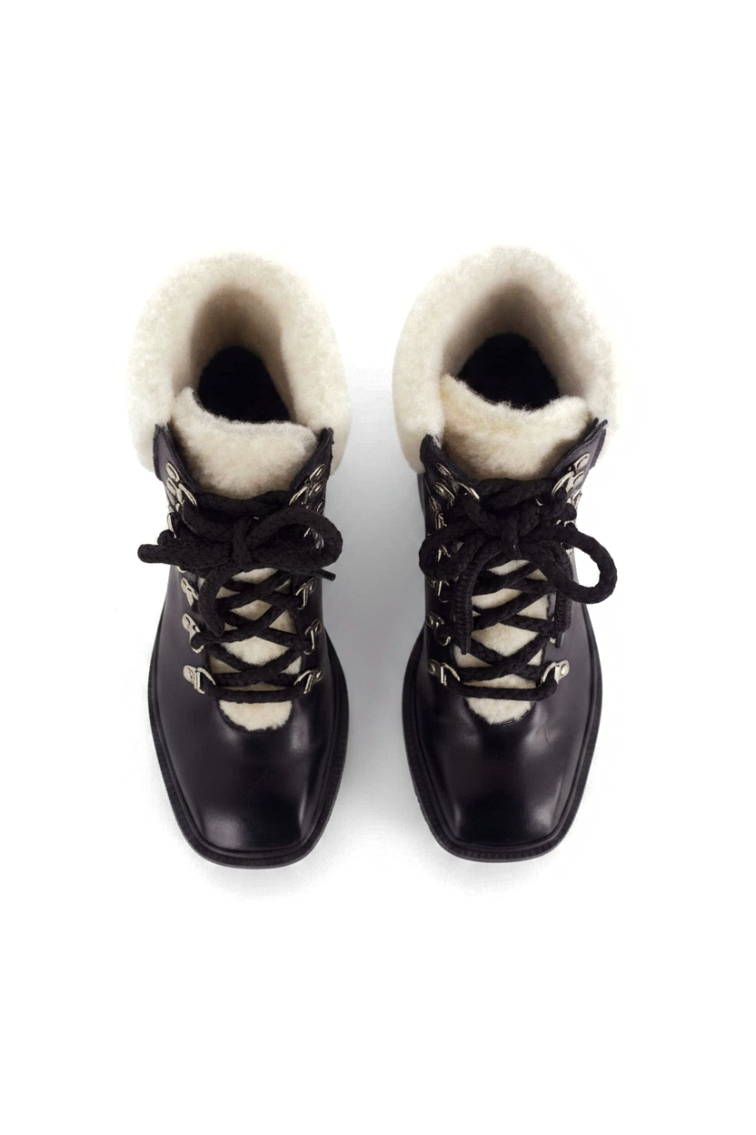 Cassia black leather combat boots top view showing the cream shearling collar and tongue