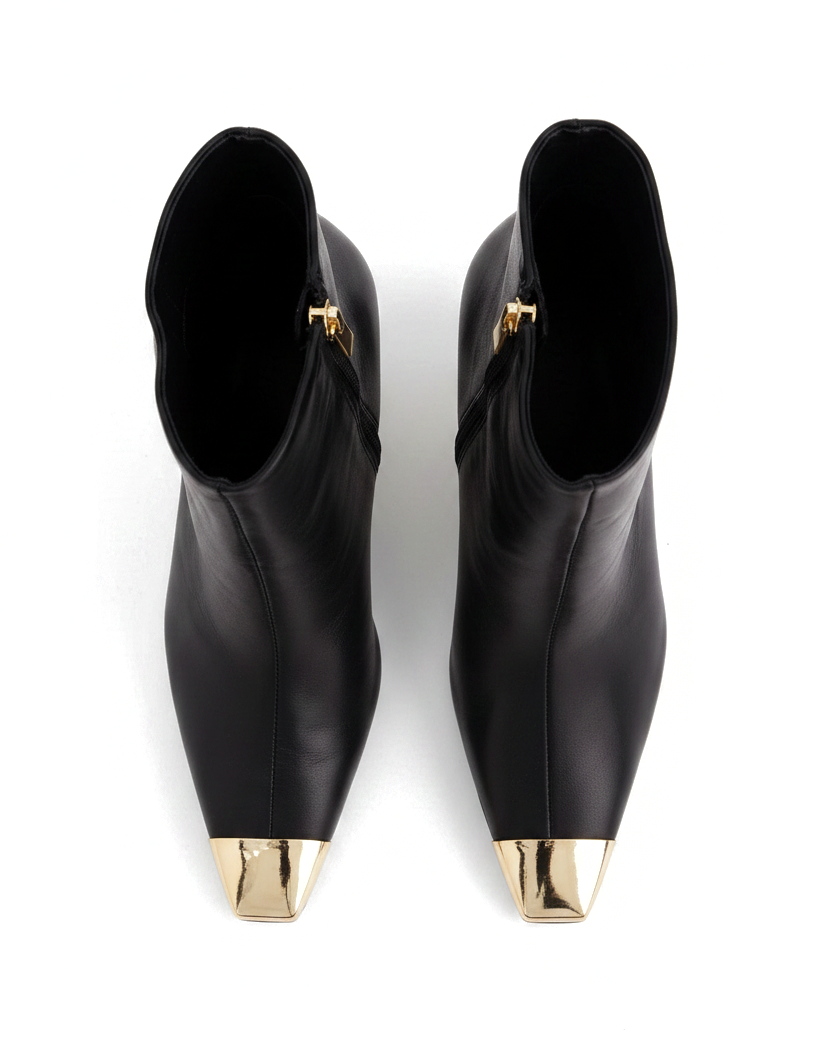 Inga black leather ankle boots top view showing the pointed gold toe caps