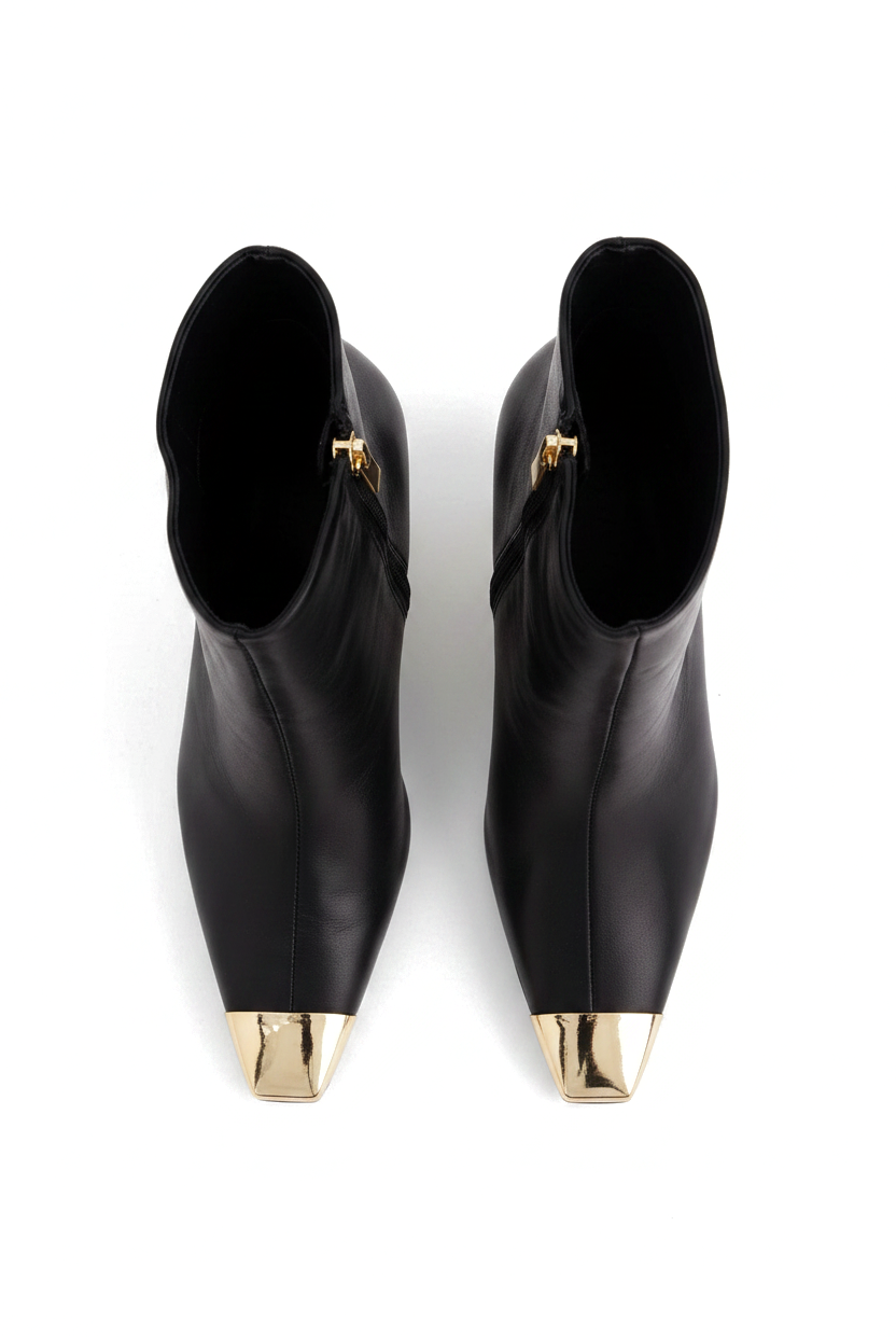 Inga black leather ankle boots top view showing the pointed gold toe caps