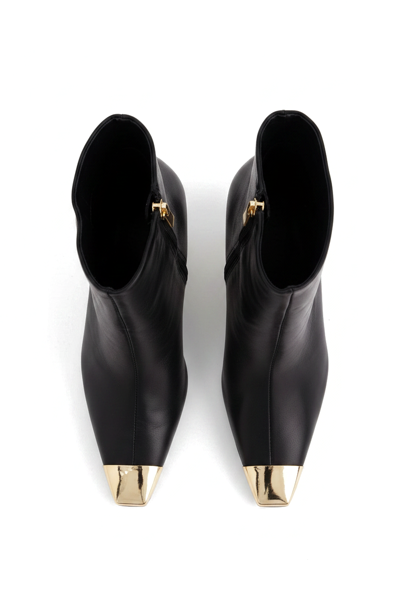 Inga black leather ankle boots top view showing the pointed gold toe caps