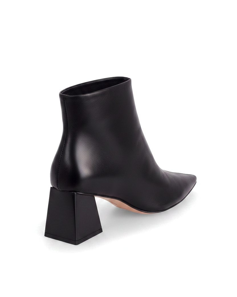 Mabea black leather ankle boots, three quarter rear view showing the flared trapeze heel