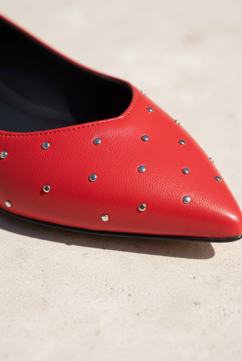 Close-up of Hamelia red leather ballerina scattered silver studs