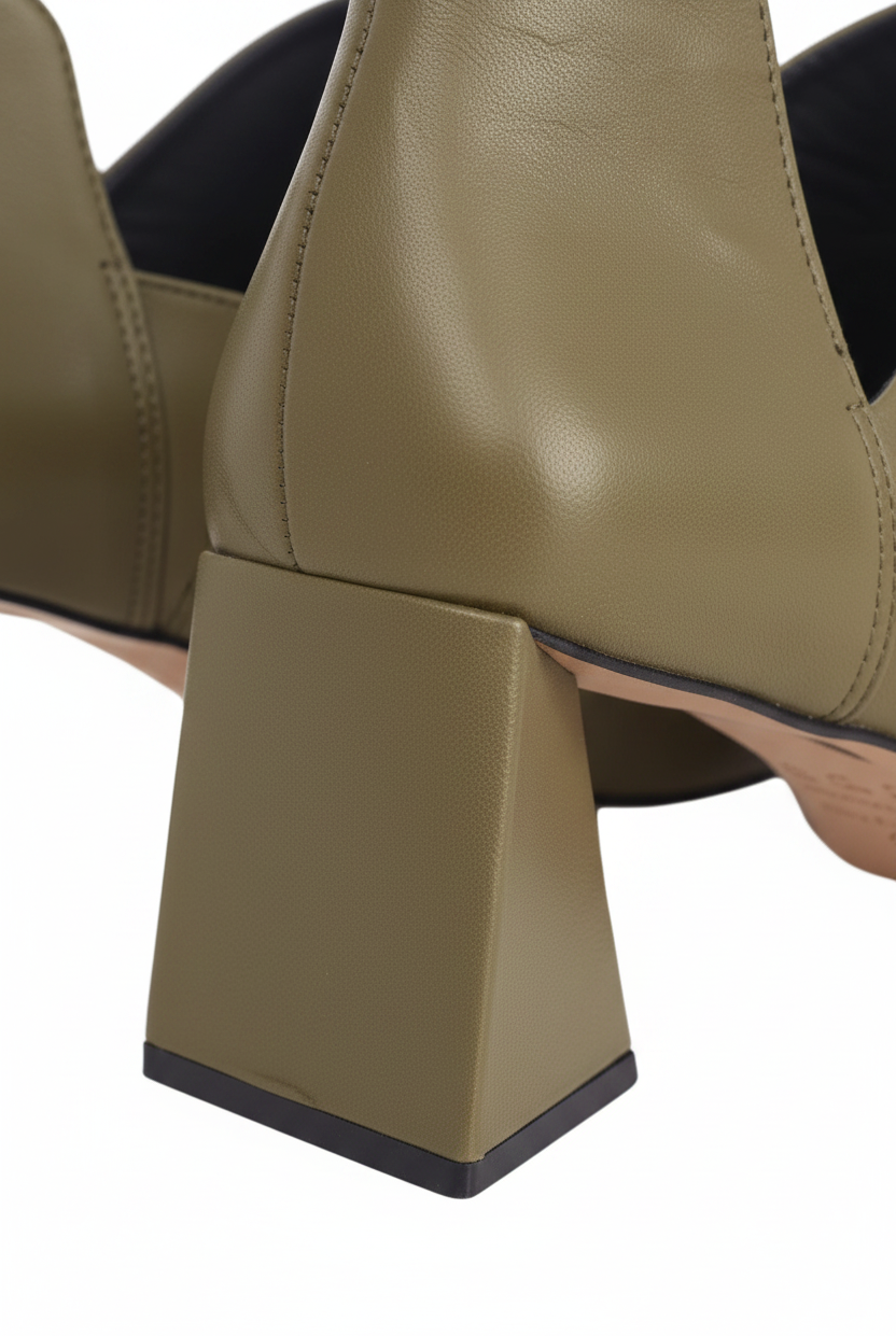 Close up of the flared trapeze block heel on Maranta olive green leather ankle boots