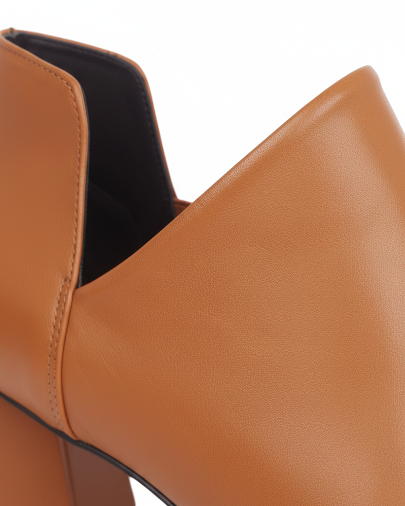 Close up of the deep V side cut and elastic gore on Maranta caramel brown leather ankle boots