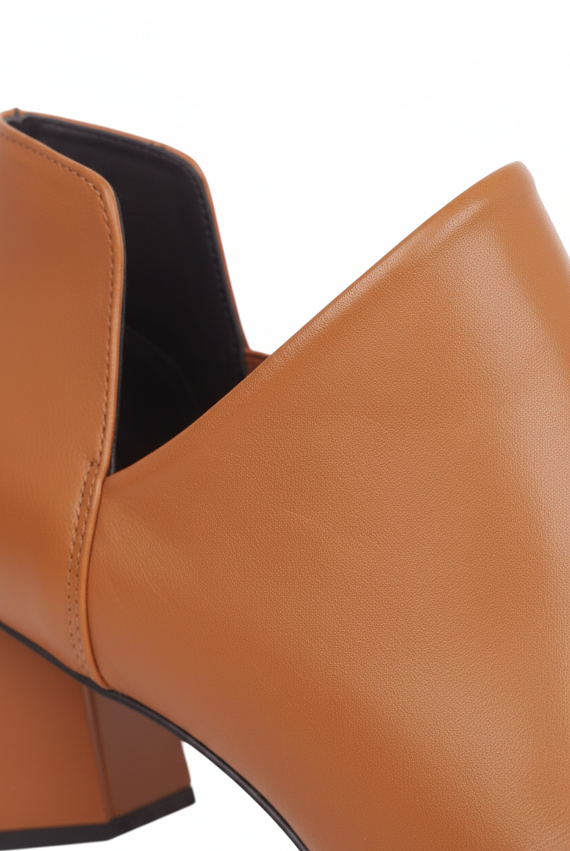 Close up of the deep V side cut and elastic gore on Maranta caramel brown leather ankle boots