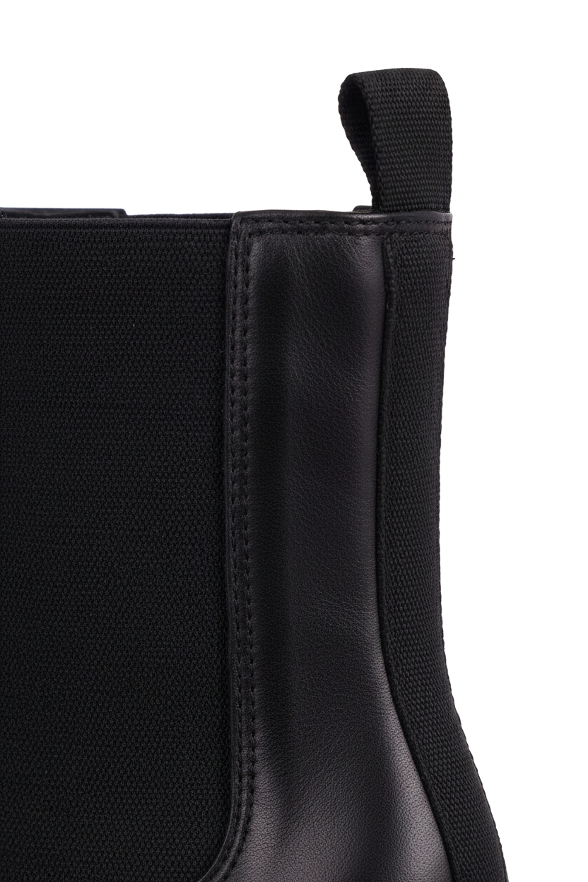 Close up detail of the woven elastic gore and pull tab on the Canna black Chelsea boots