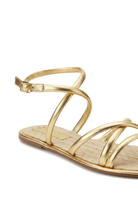 Close-up of the knotted straps, buckle and woven raffia footbed on the Mangará Angico gold sandal