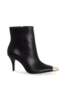 Inga black leather ankle boots side view with gold toe cap and 8.7cm stiletto heel