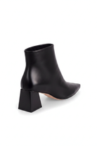 Mabea black leather ankle boots, three quarter rear view showing the flared trapeze heel