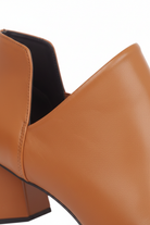 Close up of the deep V side cut and elastic gore on Maranta caramel brown leather ankle boots