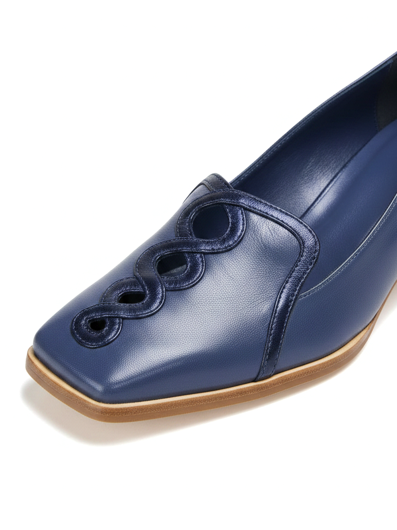 Close-up of the interlaced metallic blue leather chain and piping on Mangara Cordia navy leather loafers