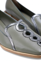 Close up detail of the interlocking silver leather chain on the Cordia green loafers