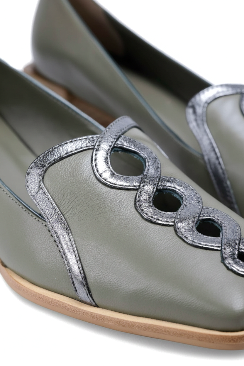 Close up detail of the interlocking silver leather chain on the Cordia green loafers