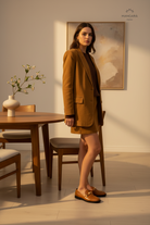 Caetê Caramel Leather Loafers – Gold Studs, 3cm Block Heel — AI-generated editorial photo